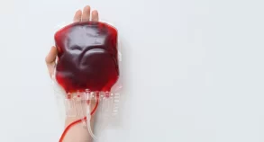 A woman’s hand holding a blood bag.