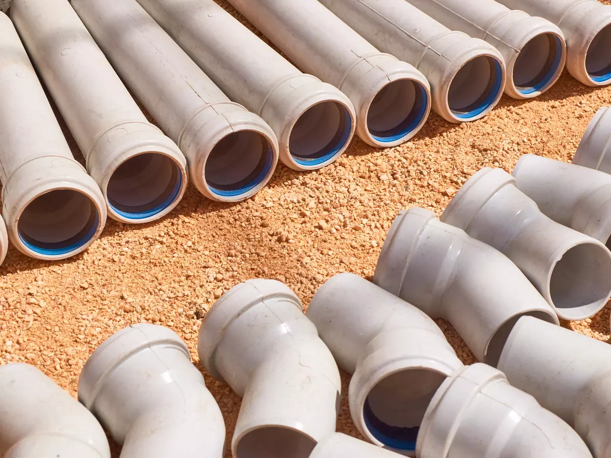 Vinyl PVC pipes lined up in the dirt
